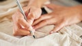 Making sure her seams are accurate. Closeup shot of a woman designing a garment in her workshop.