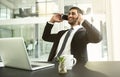 Making sure that his clients stay informed. a businessman talking on his cellphone with his laptop in front of him. Royalty Free Stock Photo