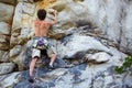 Making sure that its stable. A rock climber trying to get a grip on the cliff face. Royalty Free Stock Photo