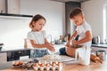 Making sweets. Little boy and girl preparing Christmas cookies on the kitchen Royalty Free Stock Photo