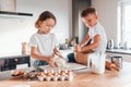 Making sweets. Little boy and girl preparing Christmas cookies on the kitchen Royalty Free Stock Photo