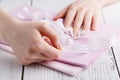 Making table decorations. A shot of woman sewing a natural beige linen tablecloth, towels and napkins with rose print and a croche