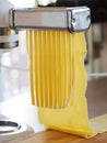Making tagliatelle with a pasta machine. Royalty Free Stock Photo