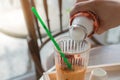 Making tea into ice cubes in glass and served with hot milk, Pouring the hot milk on Thai Tea ice cubes for drinking Royalty Free Stock Photo