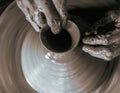 Pottery wheel with potter`s hands . Royalty Free Stock Photo