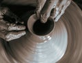 Pottery wheel with potter`s hands . Royalty Free Stock Photo