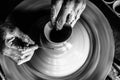 Pottery wheel with potter`s hands .