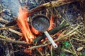 Making tea at the stake during a hike Royalty Free Stock Photo