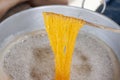 Making Thai dessert Golden Egg yolk threads Foi Thong in a pot