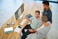 Making their ideas a reality. High angle shot of three designers working together on a project in an office. Royalty Free Stock Photo