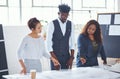 Making their plans go bigger than imagined. a team of professionals working on blueprints in an office. Royalty Free Stock Photo