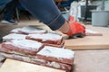 Making tiles for old brick. Gloved hands carpenter table bricks covered plaster Royalty Free Stock Photo