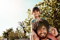 Making time to bond every chance they get. Portrait of a father giving his little daughter a piggyback ride outdoors. Royalty Free Stock Photo