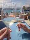 Making a toast with white wine near the Yatchs