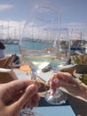 Making a toast with white wine near the Yatchs