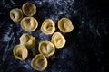 Making tortellini pasta from italian flour semolina, eggs, mushrooms top view