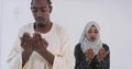 African black muslim couple at home in ramadan Making Traditional Fatiha Prayer To Allah God While Wearing A Traditional