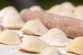 Making traditional food pierogy with dough roller