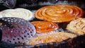 Making of traditional street food jilebi ,frying deep of maida or plain flour batter before soaking in sugary syrup