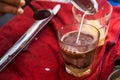 Making traditional Thai milk tea using coffee bag in Stainless Steel Pot. Old Thai tea made shop street food Royalty Free Stock Photo