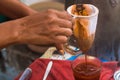 Making traditional Thai milk tea using coffee bag in Stainless Steel Pot. Old Thai tea made shop street food Royalty Free Stock Photo