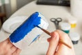 Coloring papier mache. Making utensils from paper mache. The child paints with a brush a blank of paper in the shape of a glass Royalty Free Stock Photo