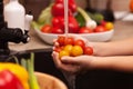 Making a vegetables salad, washing ingredients - cherry tomatoes