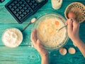 Making waffles at home - waffle iron, batter in bowl and ingredients - milk, eggs and flour. Royalty Free Stock Photo