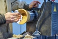 Making a wooden vase on a lathe.