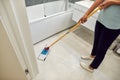 Making your house super clean. Cropped photo of a female professional cleaner cleaning the floor with mop in the Royalty Free Stock Photo