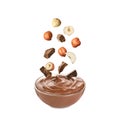 Making yummy chocolate paste. Hazelnuts and pieces of chocolate falling into bowl on white background Royalty Free Stock Photo