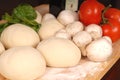 The makings for a fresh homemade pizza on a cutting board