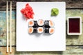 Makisushi on white plate. Seafood traditional maki sushi rolls with chopsticks Royalty Free Stock Photo