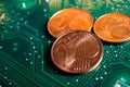 Makro close up of isolated glowing blurred pile euro cent coins on green motherboard