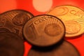 Makro close up of pile one and two euro cent copper coins on shiny red background Royalty Free Stock Photo