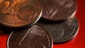 Makro close up of pile one and two euro cent copper coins on shiny red background Royalty Free Stock Photo