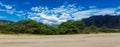 Makua beach panoramic view with beatiful mountains and cloudy sky in the background, Oahu island