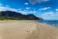 Makua beach view with beatiful mountains and cloudy sky in the background, Oahu island