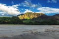 Makua beach view with beatiful mountains and cloudy sky in the background, Oahu island