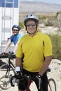 Mal Bicyclist Standing With Woman In The Background