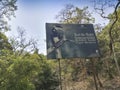 A Malaber pied horn bill, bird, Anthracoceros coronatus, also known as lesser pied hornbill, on the sign board at Dandeli Anshi