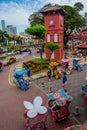 Malacca city with Malacca red square clock tower and unique trishaw people Royalty Free Stock Photo