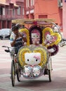 Malacca, Malaysia--February 2018: A Hello Kitty-inspired colorful trishaw along the brick-paved Dutch Square in Melaka, Malaysia,