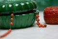 Art deco jade glass jar with sea coral beads necklace detail Royalty Free Stock Photo