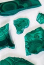 Malachite polished stones on a white background. Top view. Copy, empty space for text Royalty Free Stock Photo