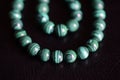 Malachite stone beads necklace on a dark background Royalty Free Stock Photo