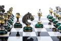 Malachite stone chess pieces on and marble chessboard