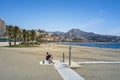 Malaga, Spain, April 2017: view on La Malagueta beach on a sunny and day with clear sky in summer. Palm trees, city architecture Royalty Free Stock Photo