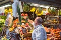 Seller at the fresh fruit stand at the market Royalty Free Stock Photo