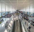 Crowd of people in a busy airport hall getting to their departure gates